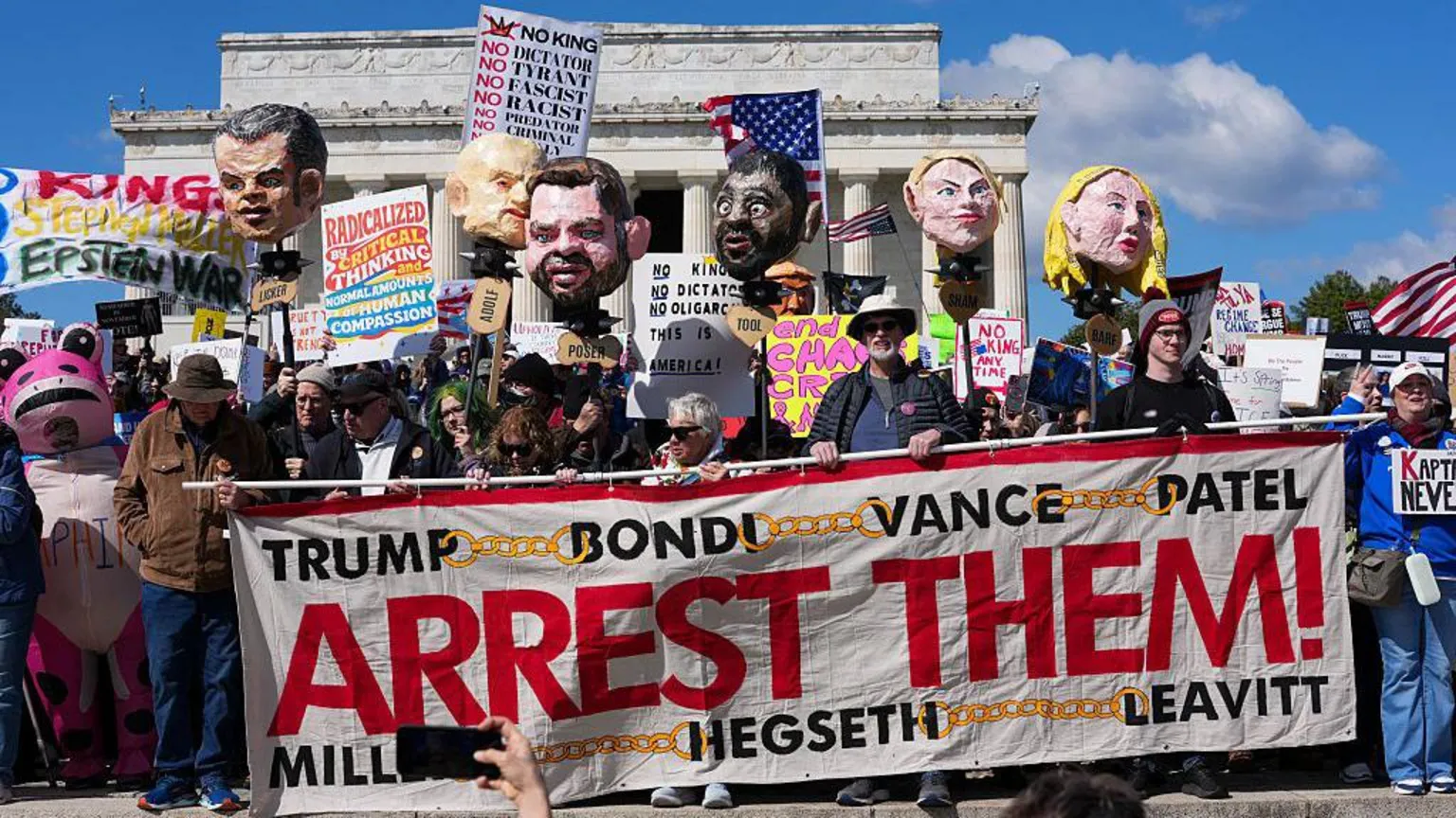  Protestors hold effigies of members of the Trump administration as well as signs calling for their arrest