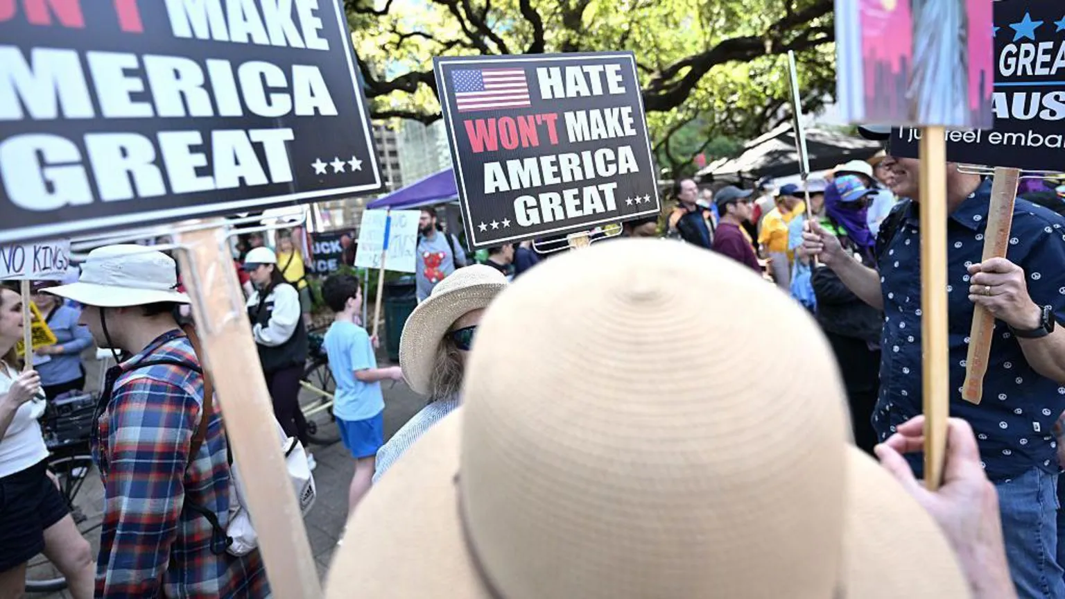  Protesters hold signs that say 