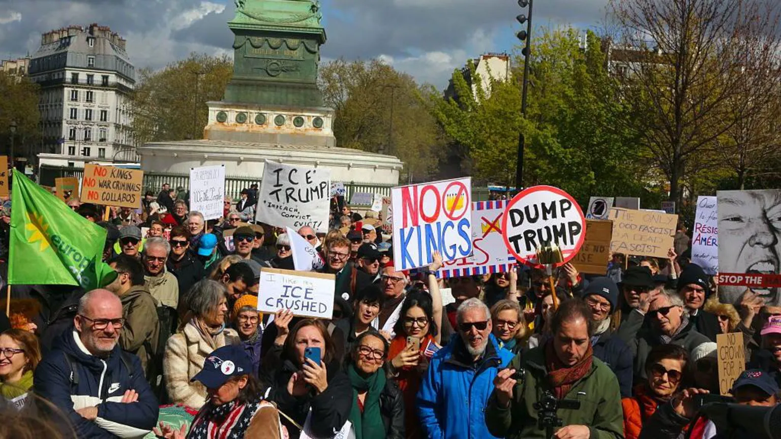  A group of protestors hold signs in Paris