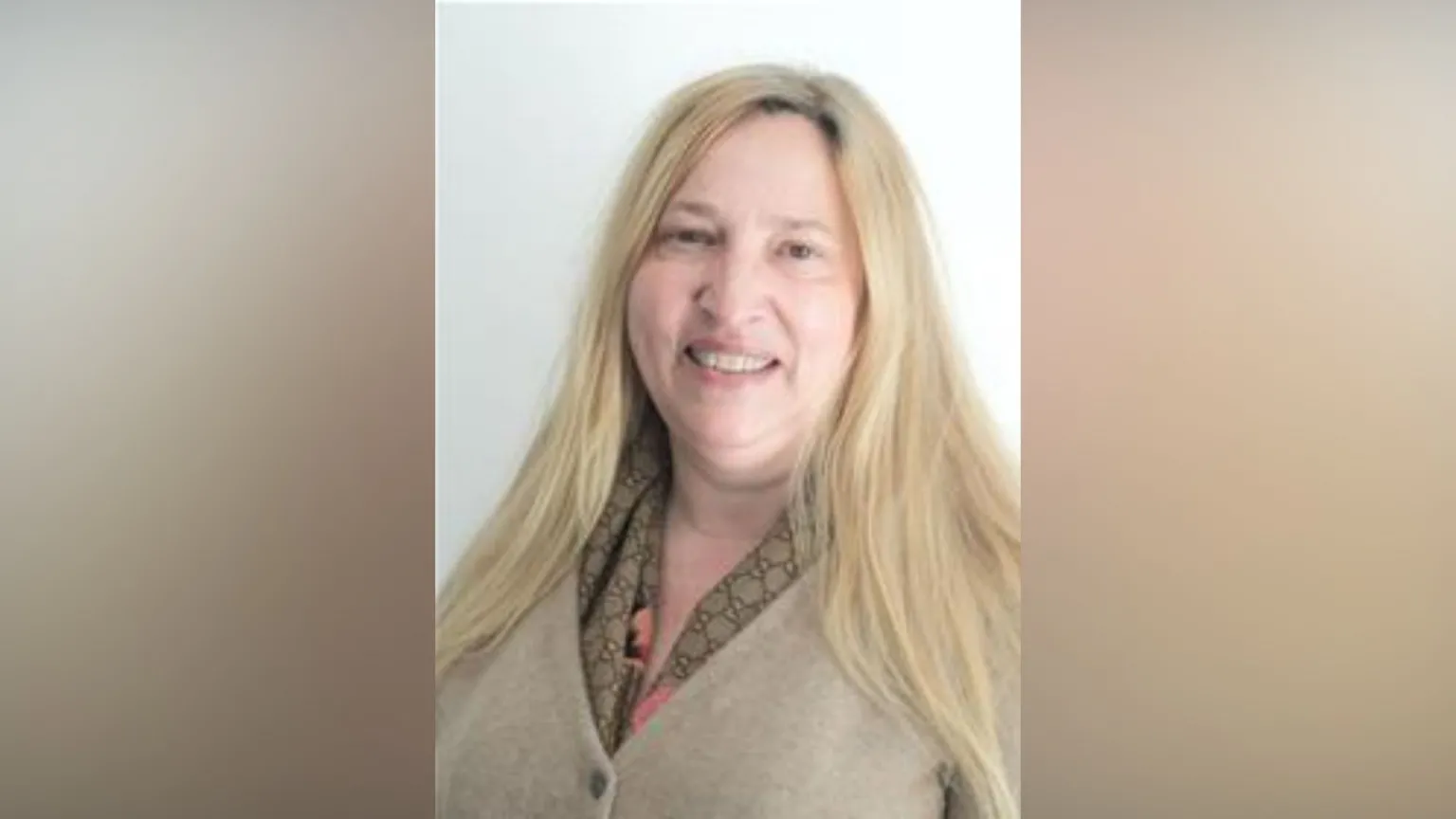 Somerset Council A woman in a cream cardigan against a blank portrait backdrop