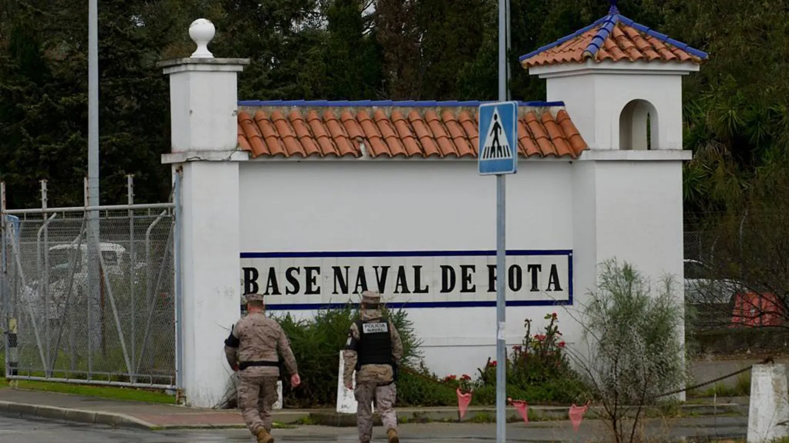  Two soldiers walk towards the naval base of Rota