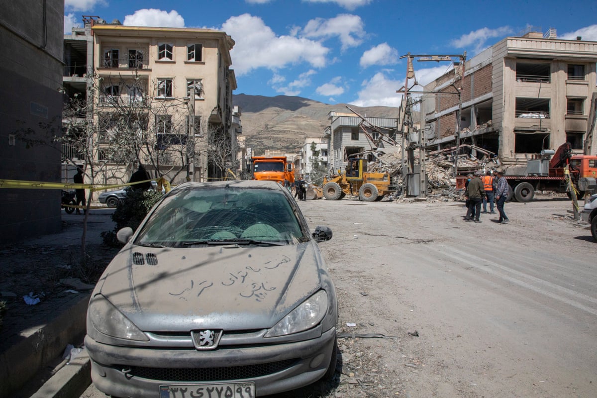 The words ‘Damn you, traitor Trump!’ is written in dust on a car parked near a residential building hit in an airstrike in the west of Tehran, Iran on March 30.
