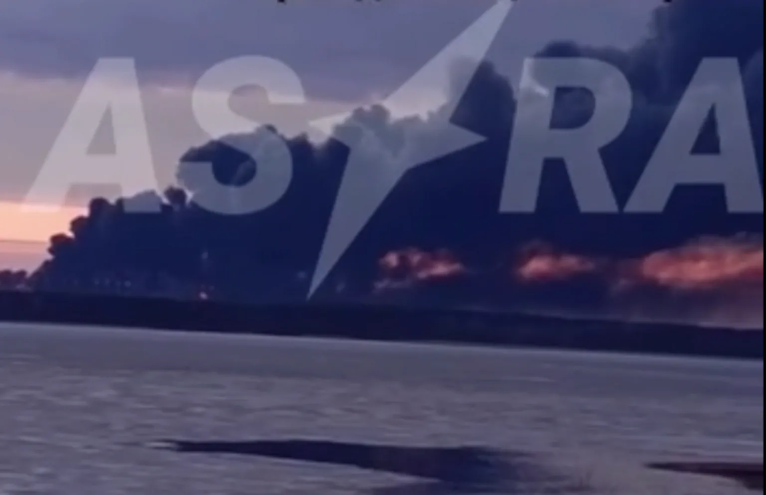 Telegram/Astrapress A large smoke plume rising into the sky over the water