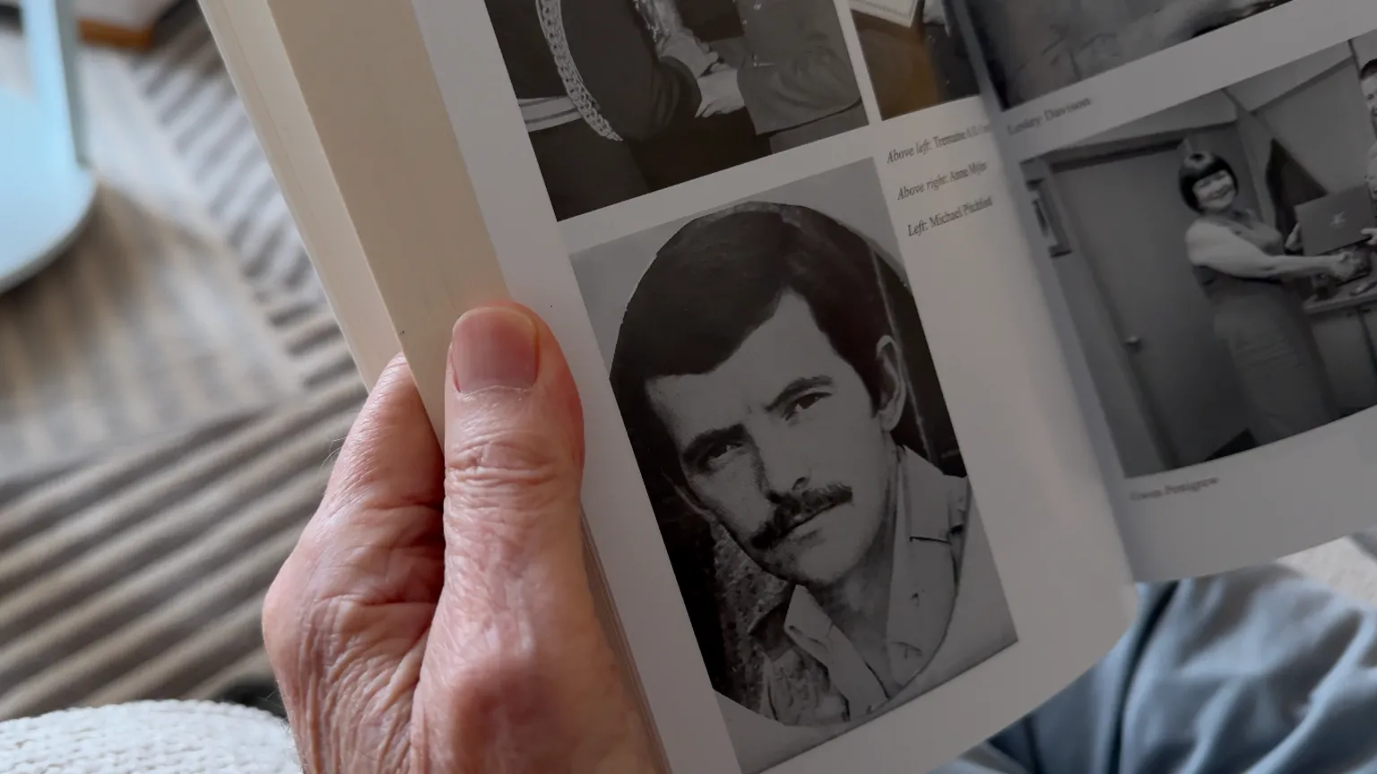 Close up image of a book showing an old black and white photograph of Michael as a young man.