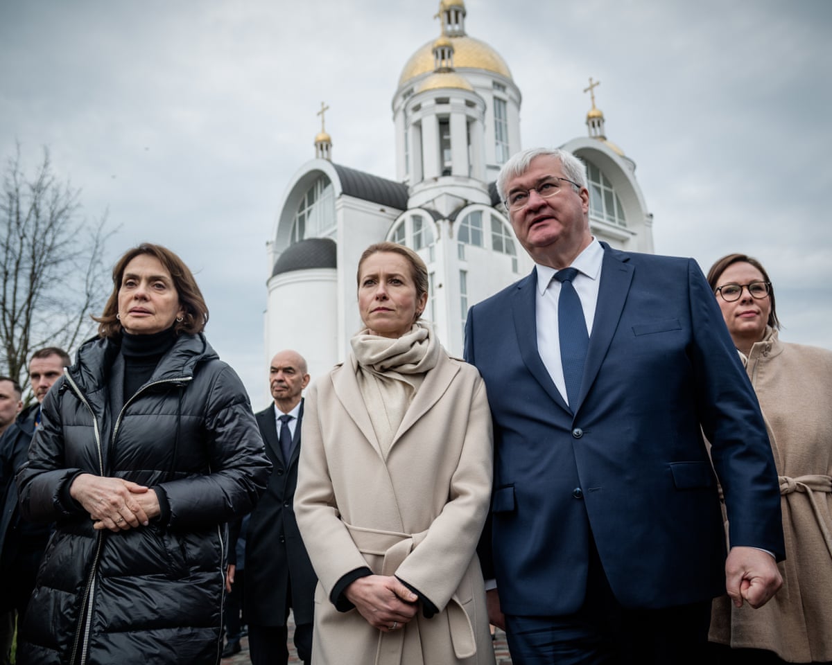 EU foreign policy chief Kaja Kallas standing next to Ukraine's foreign minister Andrii Sybiha as EU ministers attend commemorating ceremony in Bucha, Ukraine.