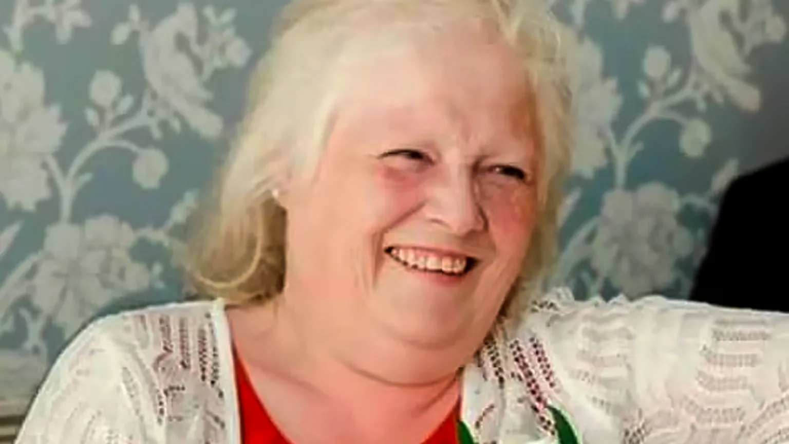 Family handout Esther Martin, who is wearing a red top and white cardigan with a flower pinned to it. She is smiling.