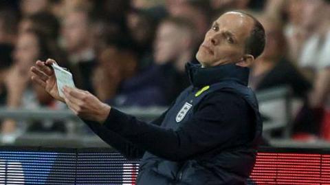 England head coach Thomas Tuchel, leaning back with arms out in front of him, looks frustrated during the defeat to Japan in the friendly at Wembley.
