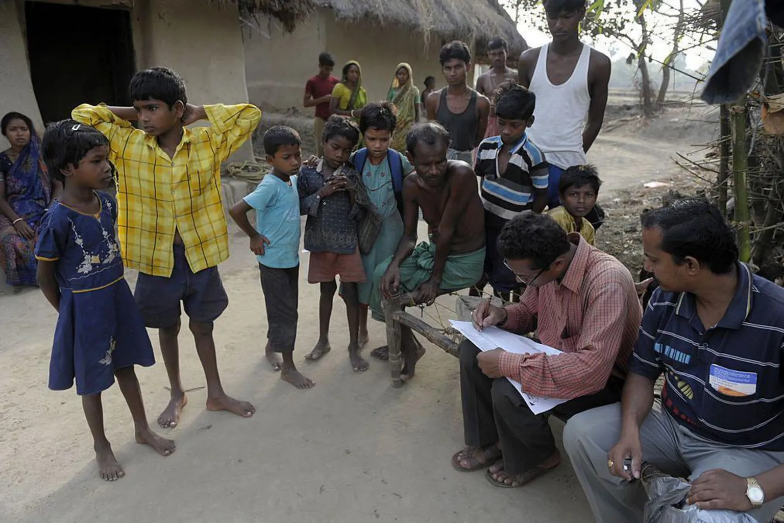 AFP via An Indian census worker (2nd R) gathers data at a village in Lalgarh, some 130 kms west of Kolkata