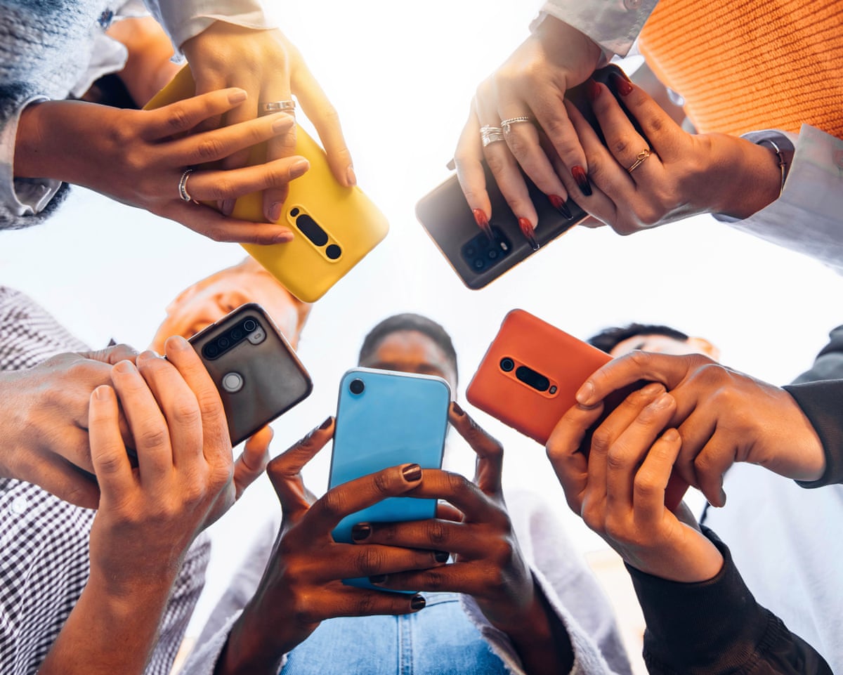 Young adults in a circle holding smartphones