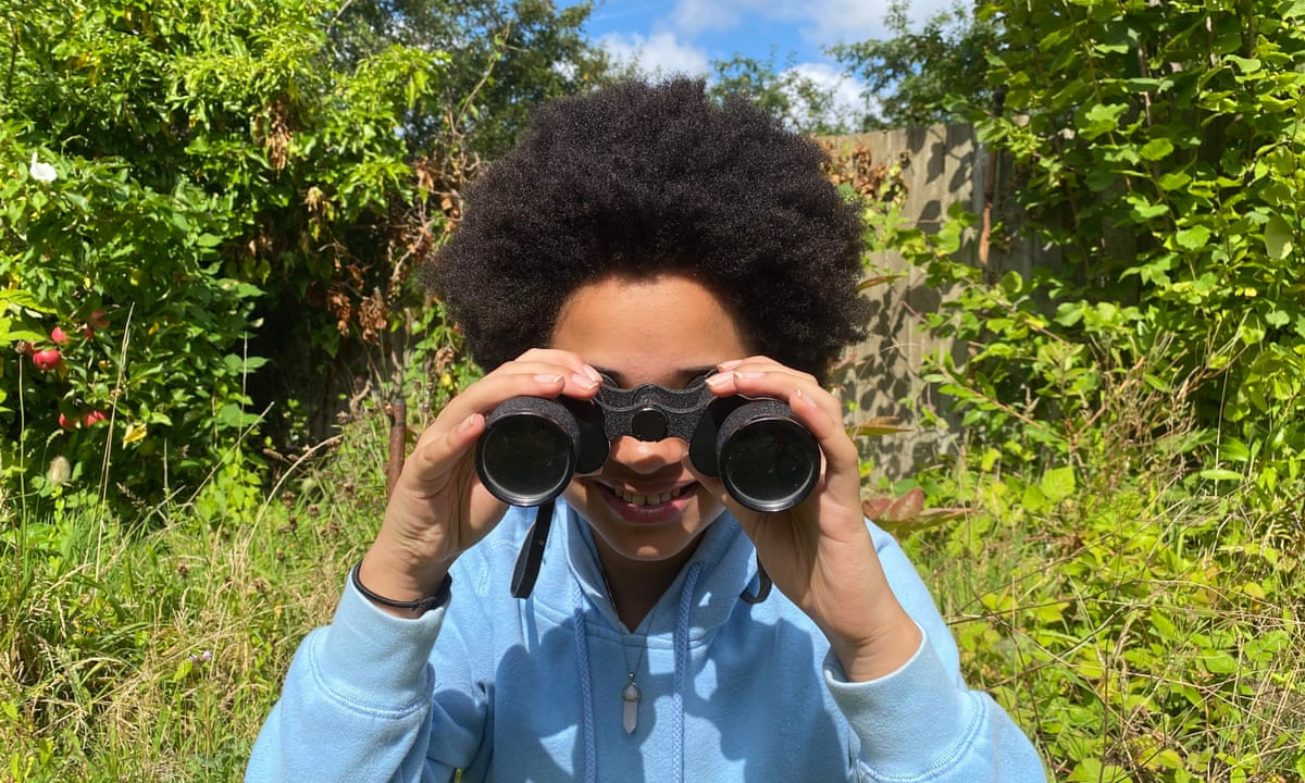Young Country Diary writer Aphra looking through her binoculars
