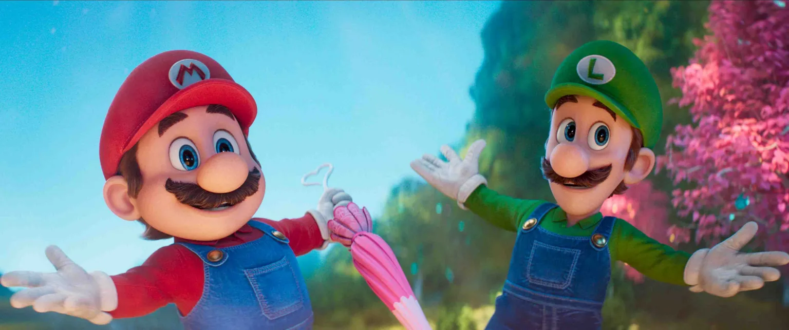 Universal Pictures Mario is wearing a red cap with a red M and red long sleeved top and blue overalls, he has a mustache and blue eyes. Luigi is wearing the same but in green, with an L on his cap