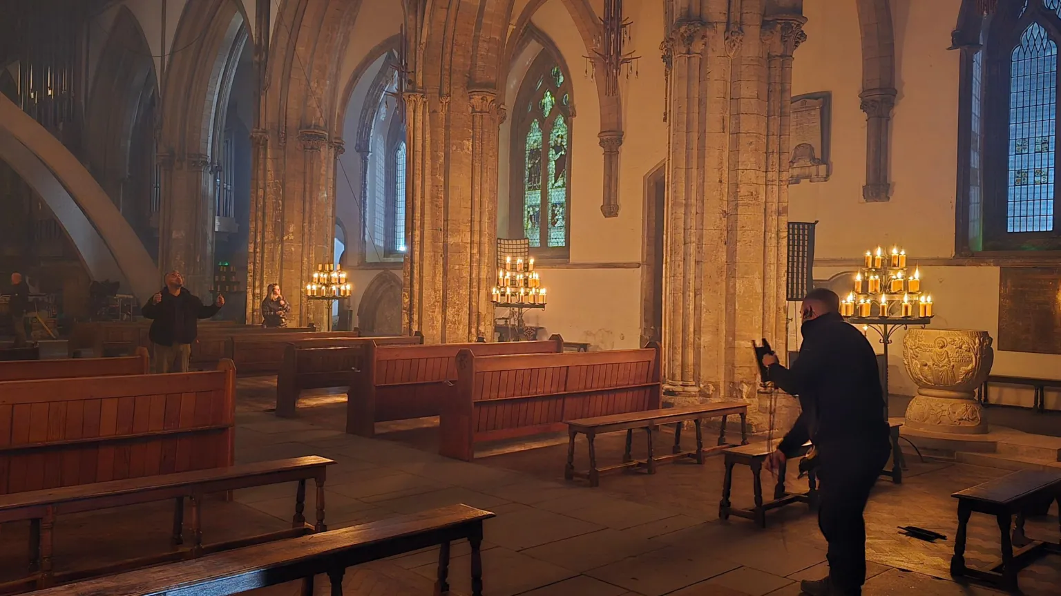 Llandaff Cathedral A film crew member inside the cathedral, let up by candles