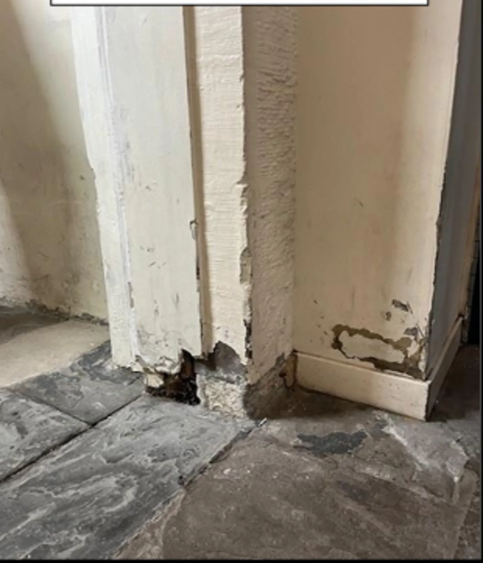 HMIPS The entrance to a cell, with chipped and broken stonework near the ground