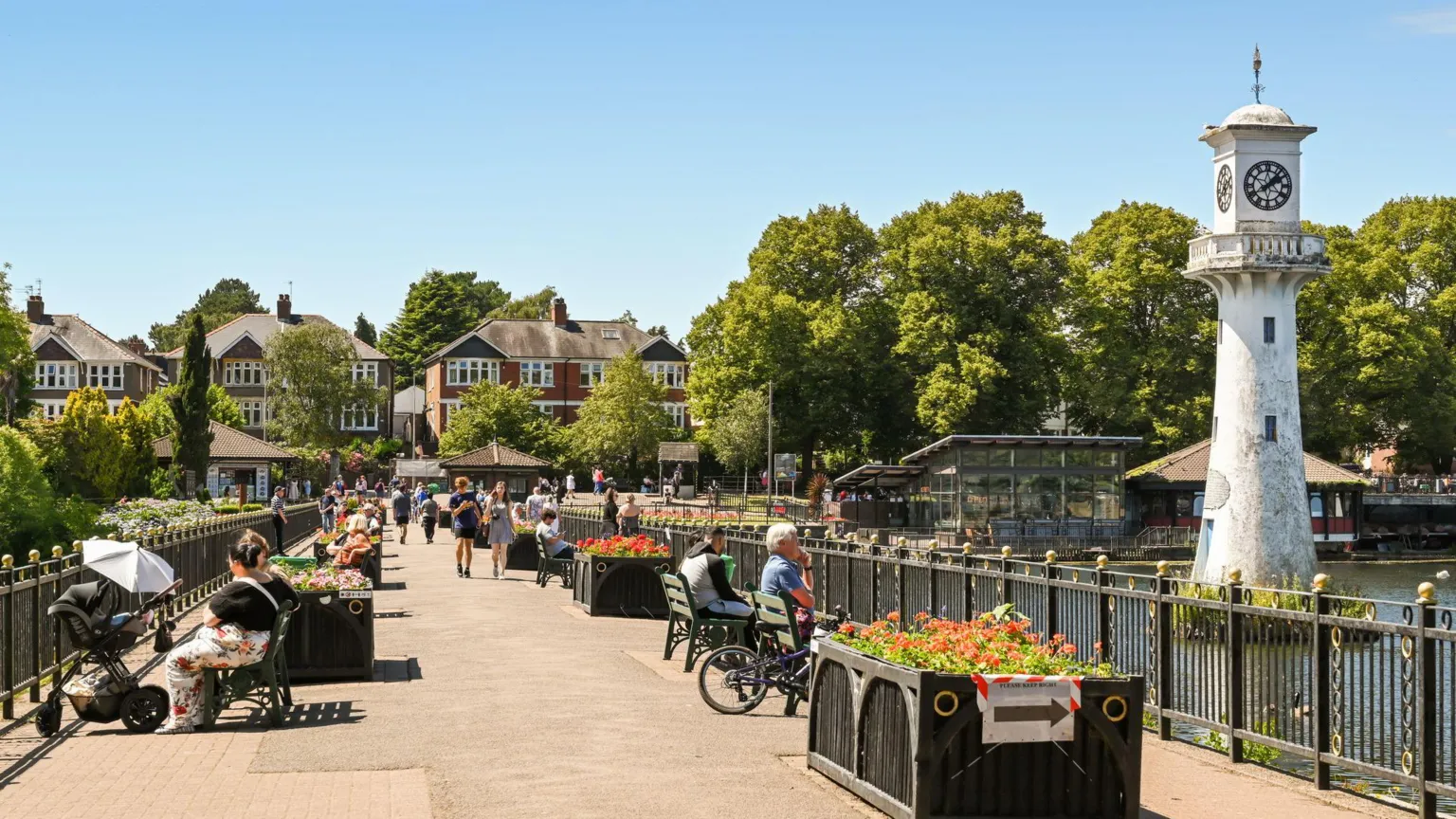  Clock tower and seating area on the promenade around Roath Lake in Cardiff