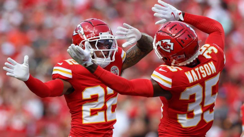 Trent McDuffie and Jaylen Watson pictured waving their hands playing for the Kansas City Chiefs before they both joined the Los Angeles Rams