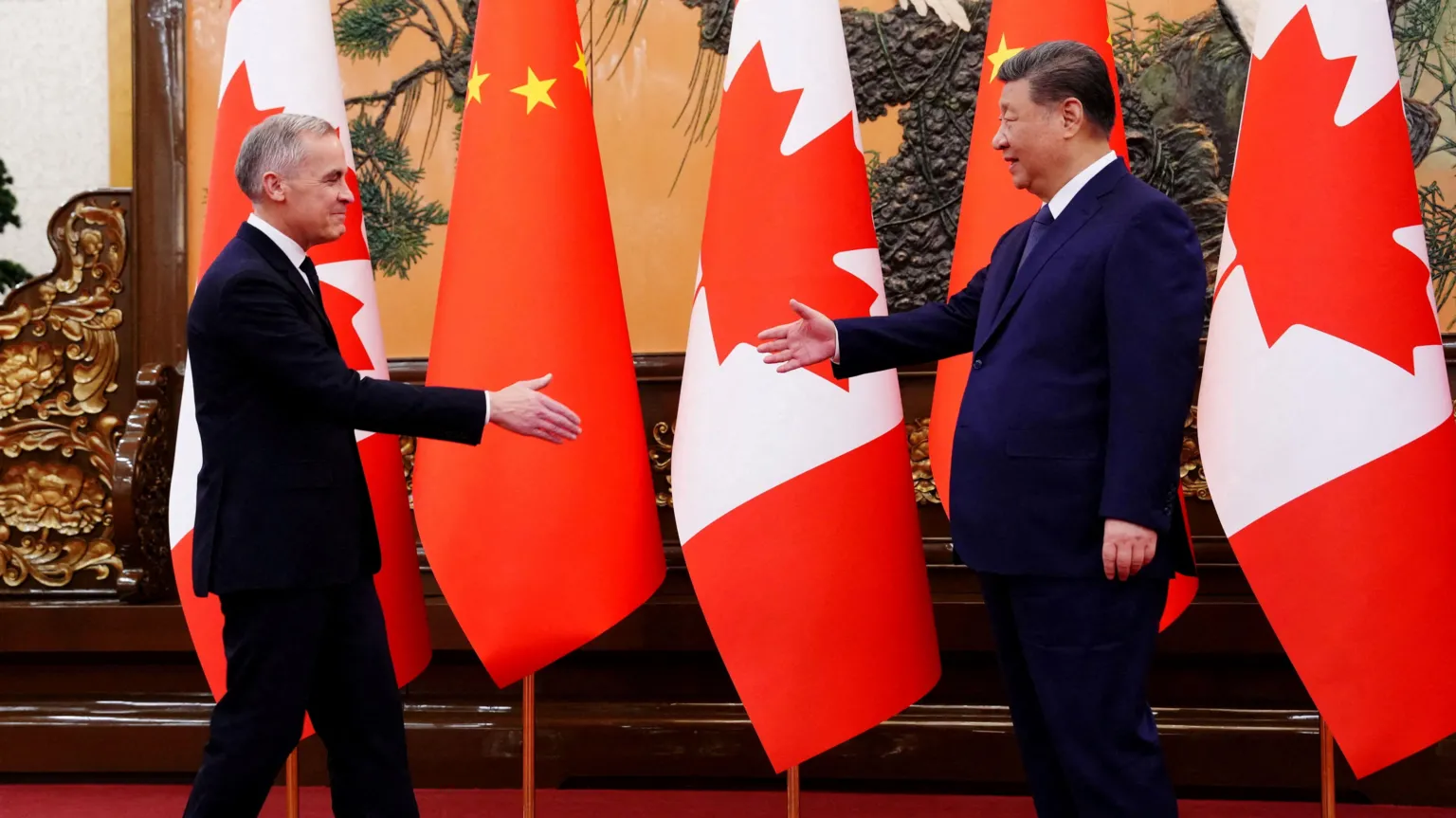 AFP Canadian Prime Minister Mark Carney walks up to President of China Xi Jinping at the Great Hall of the People in Beijing, China on Friday, Jan. 16, 2026. Both men have their hands outstretched in preparation for a shake. 
