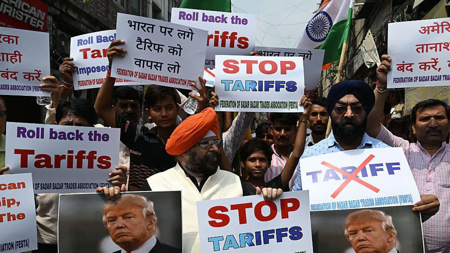 Bloomberg via Demonstrators hold signs saying stop tariffs and roll back the tariffs, with Donald Trump's picture, during a protest against US President Donald Trump's 50% tariffs on India, in New Delhi India, on Saturday, Aug. 30, 2025
