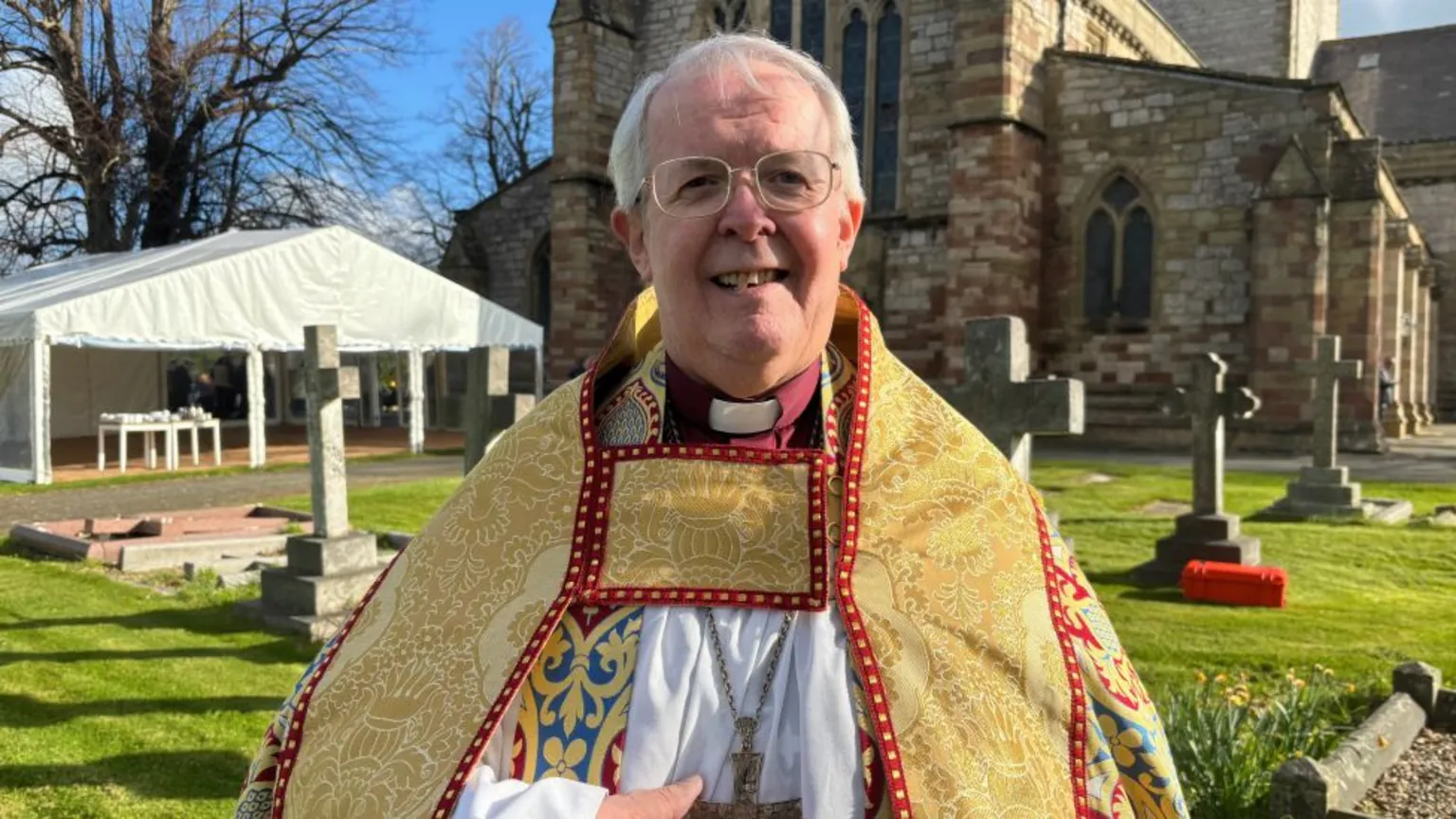 Gregory Cameron bishop of St Asaph stood outside St Asaph Cathedral