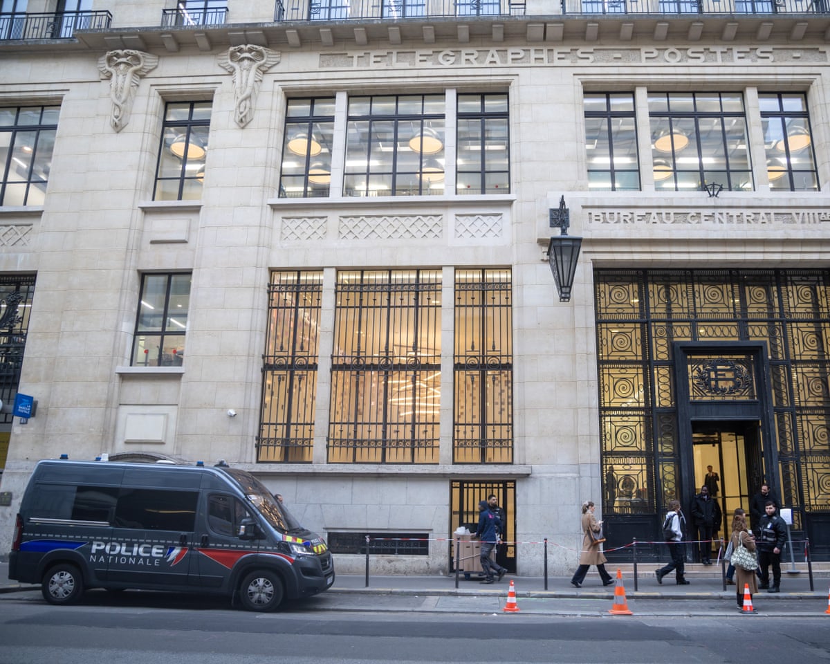 A French police van is parked outside the Bank of America headquarters in Paris, France.