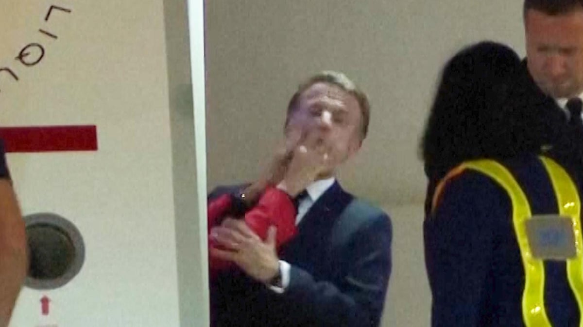 Moment Macron appears to be pushed in face by wife as they land in Vietnam – video