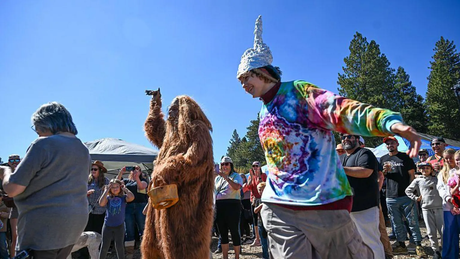 Anjali Sharif-Paul, The Sun/SCNG via Collin Ware dances around Bigfoot during the first annual Bigfoot Festival, hosted at the Running Springs Farmers Market on Saturday, Oct. 11, 2025.