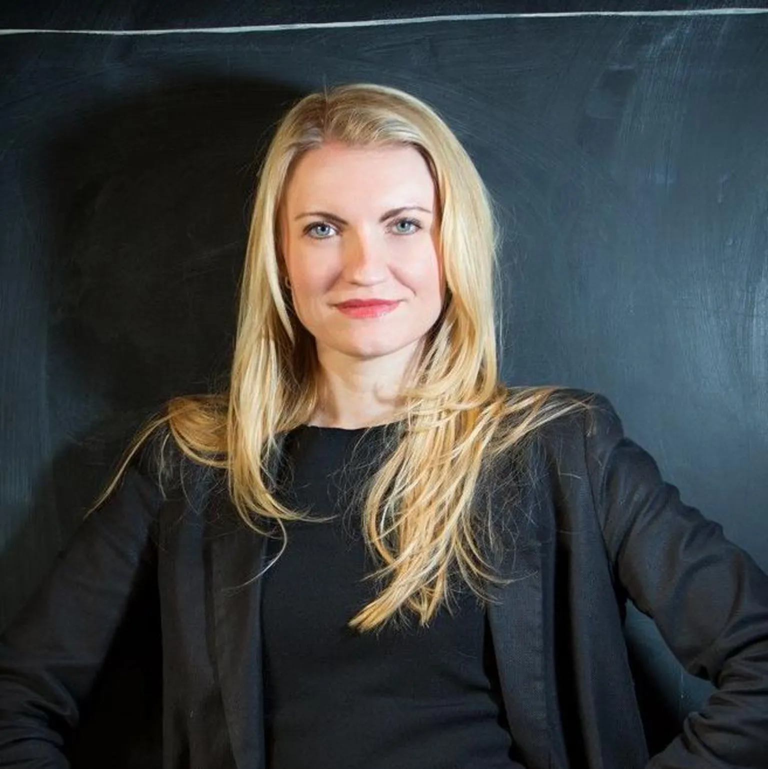 Kate Nightingale Kate, a blonde woman wearing a black top and blazer.