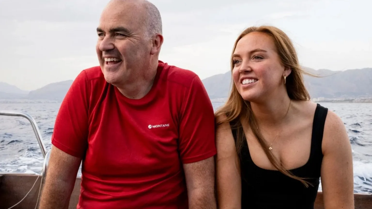BBC/Studio Lambert a man and woman on a boat, with mountains in the background
