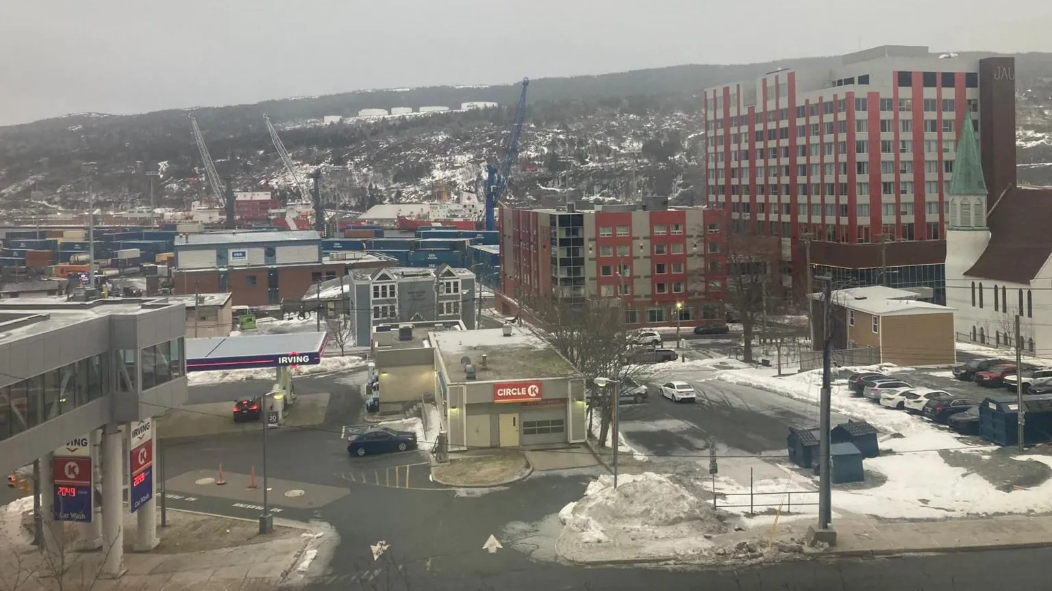 Jon Shipman Snow-covered buildings, including a petrol station and several apartment blocks. The urban views give way to a snow-capped tundra. 
