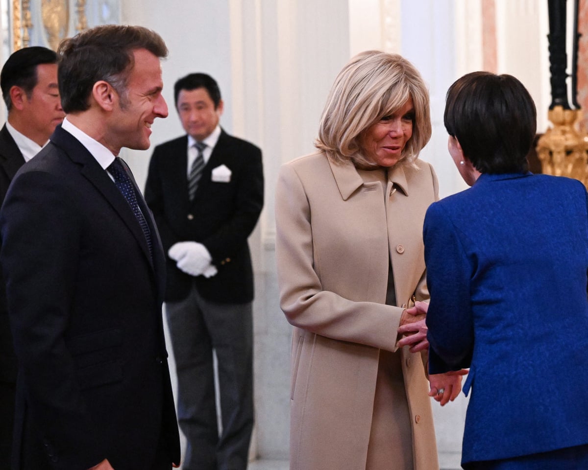 Emmanuel and Brigitte Macron are greeted by the Sanae Takaichi during a visit to Tokyo on Wednesday.