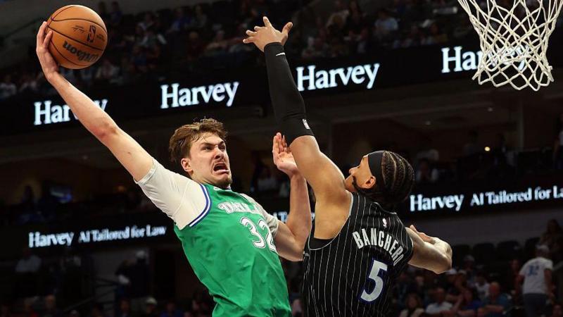 Cooper Flagg of the Dallas Mavericks goes for a dunk against Paolo Banchero