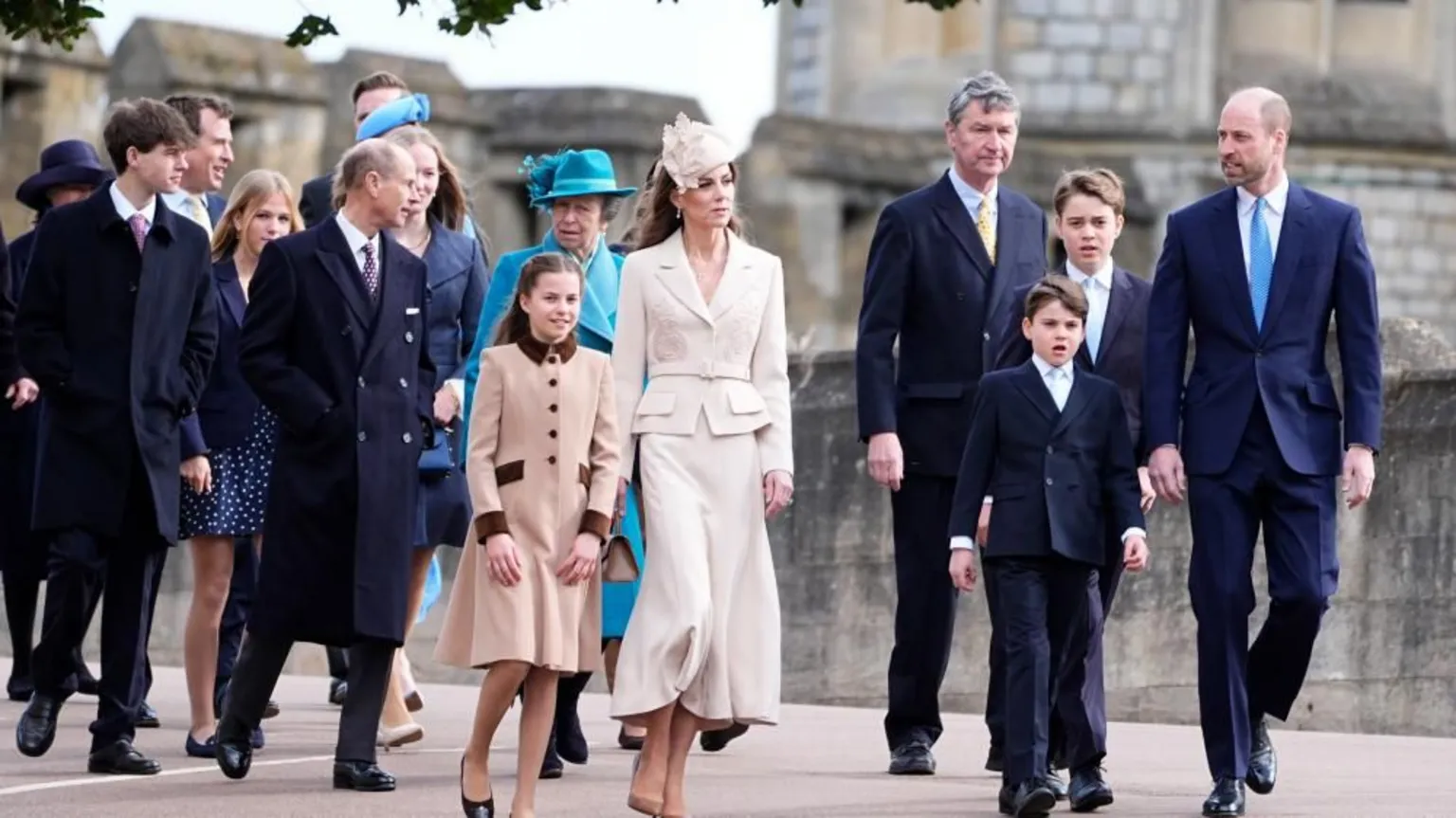  Members of the Royal Family walking along on a road. Princess Anne, Princess Catherine, Prince William and their children are photographed 