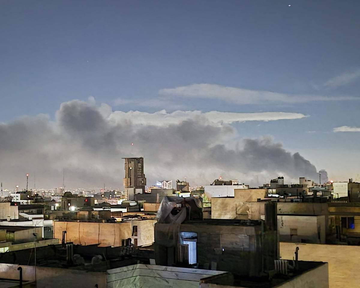 Smoke rises from residential areas in eastern and western parts of Tehran after US-Israeli airstrikes on Monday