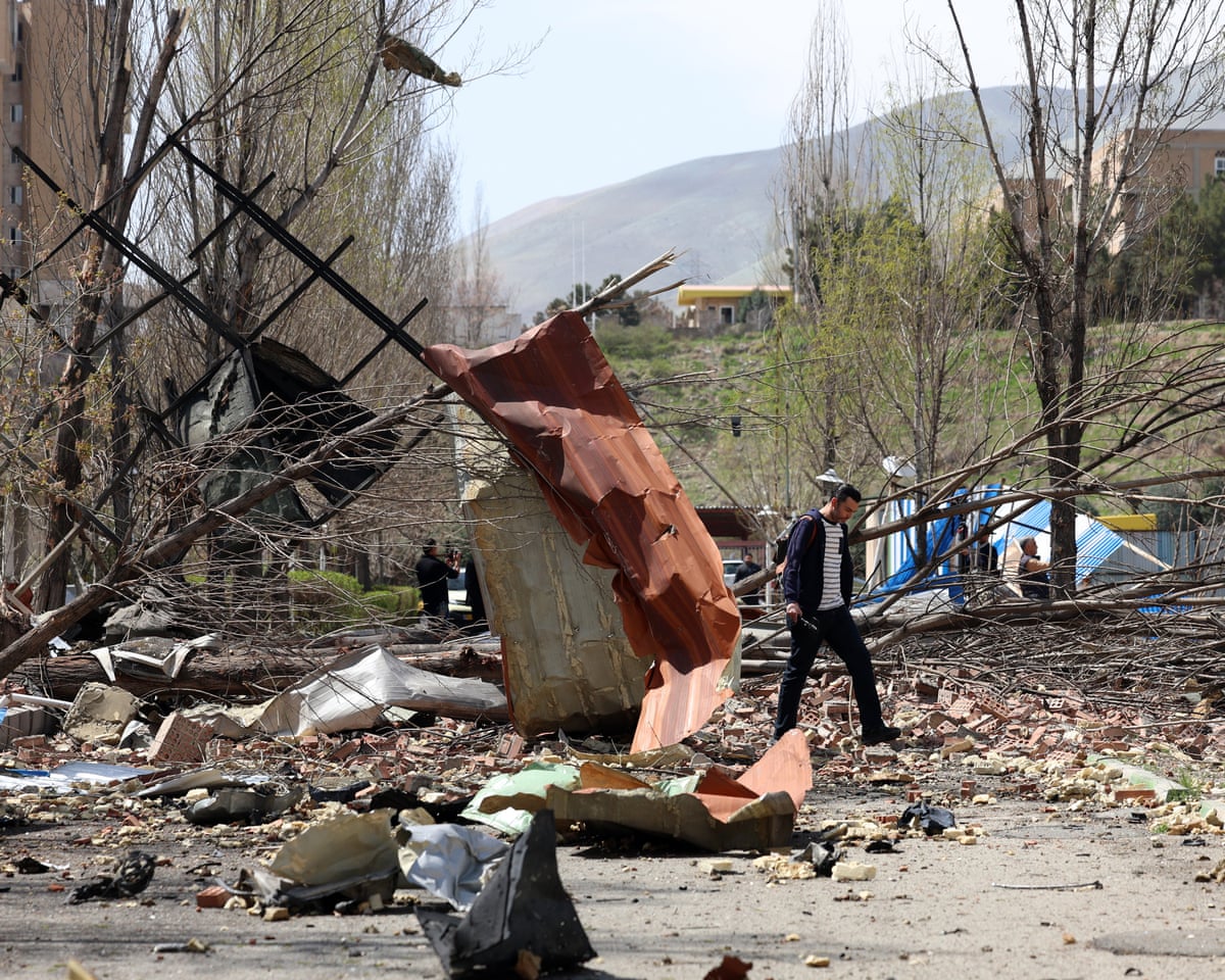 People walk amid the debris after US-Israeli airstrikes on Shahid Beheshti university in Tehran on Saturday.