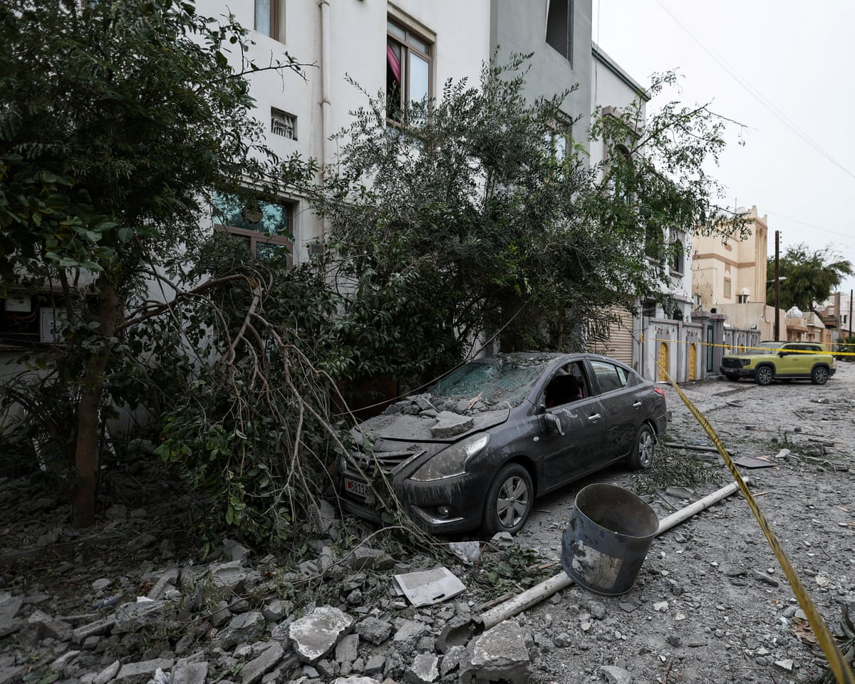A wrecked car near damaged buildings at the site of what Bahrain said was falling debris of an intercepted Iranian drone at the weekend
