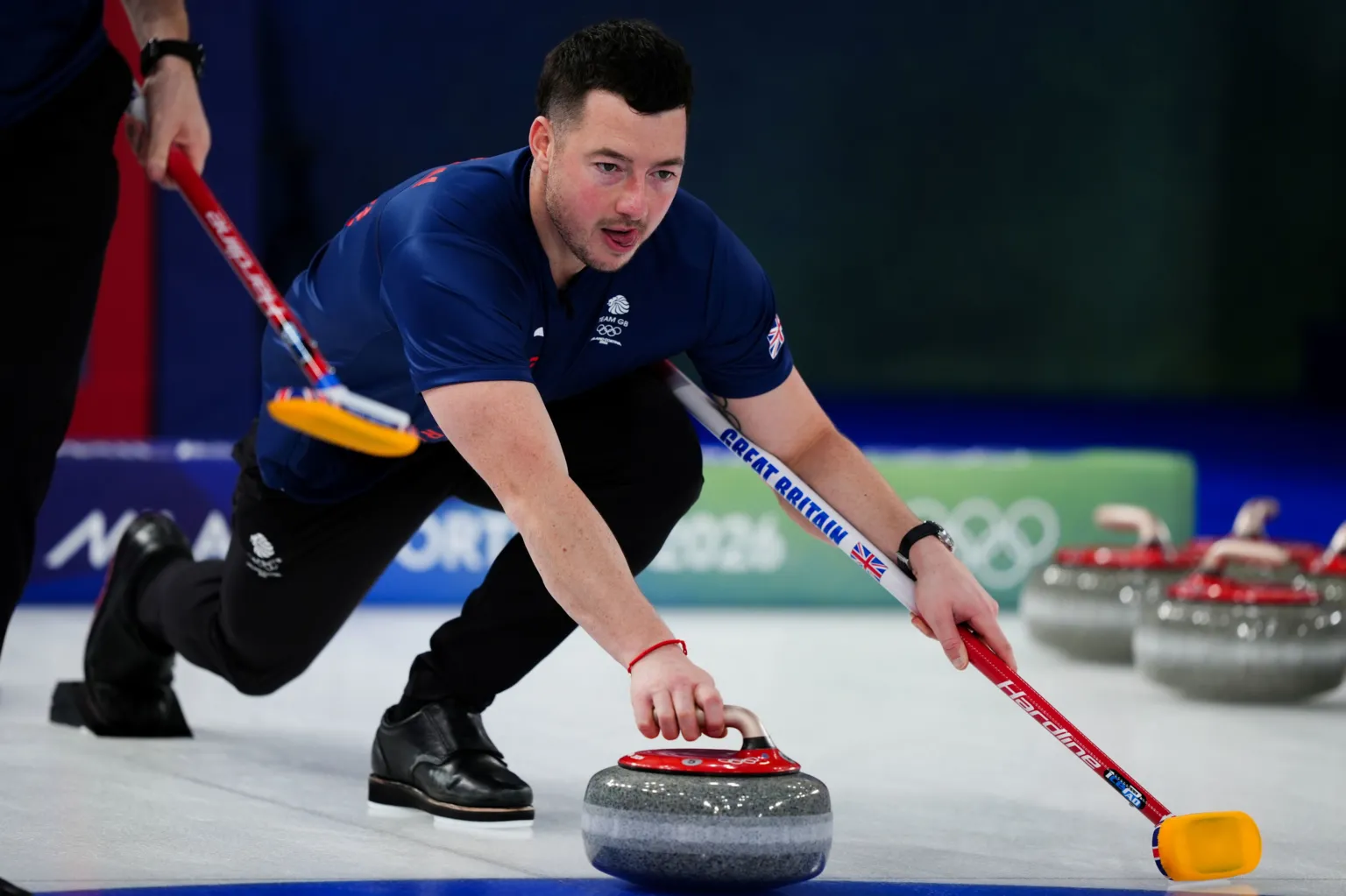 Hammy McMillan playing a shot during the Winter Olympics in Milan Cortina.