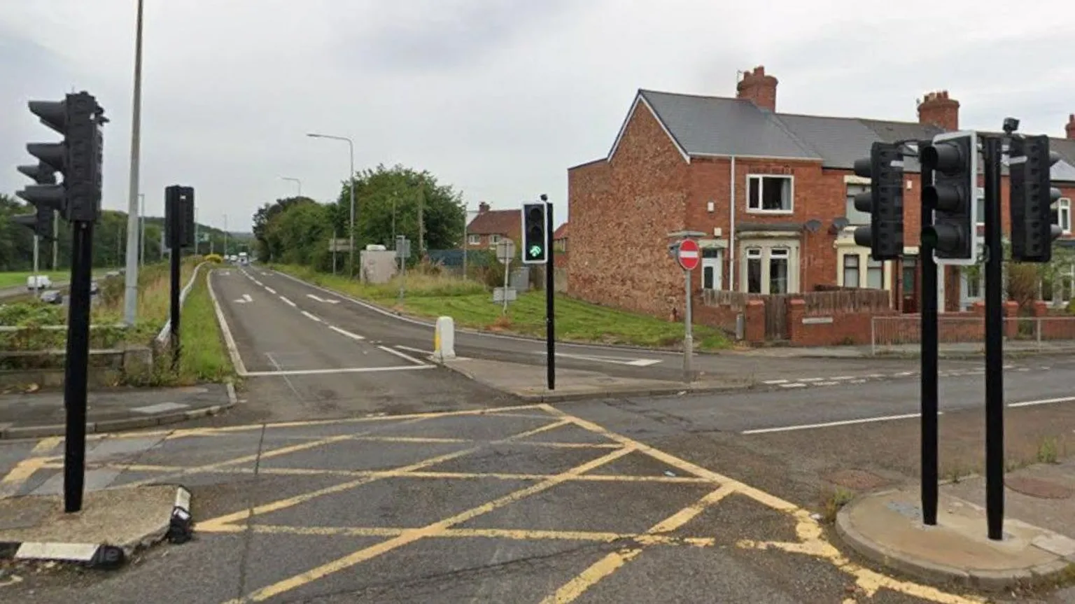 Google The junction where the crash occurred. A road leads up from the A1 and meets at a T-junction controlled by traffic lights on Dunston Road. A large yellow hatched box is painted on the road surface and there is a row of terrace houses next to the junction.