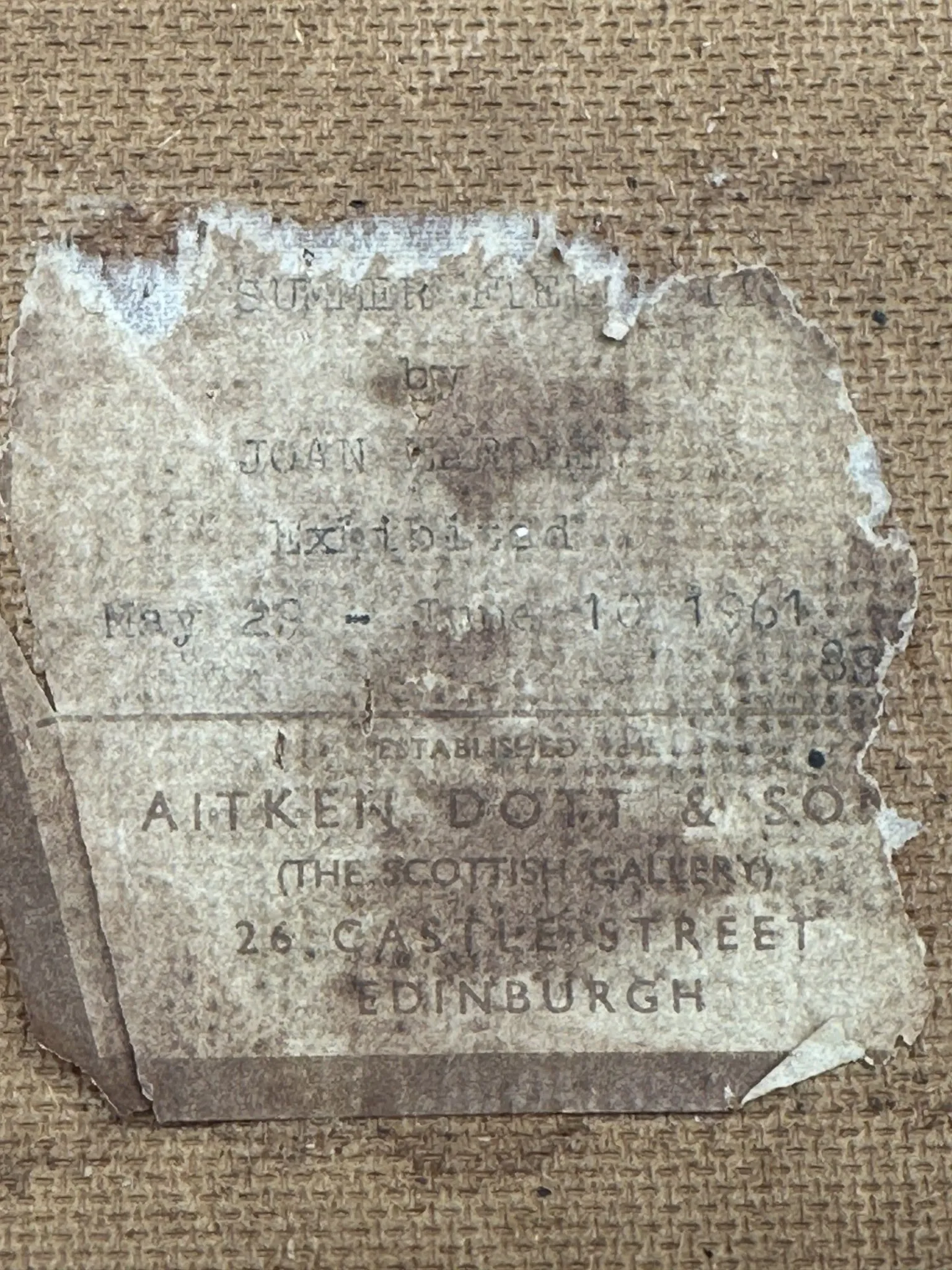 The Scottish Gallery Close-up of a worn, torn label attached to the back of a canvas, with faded text