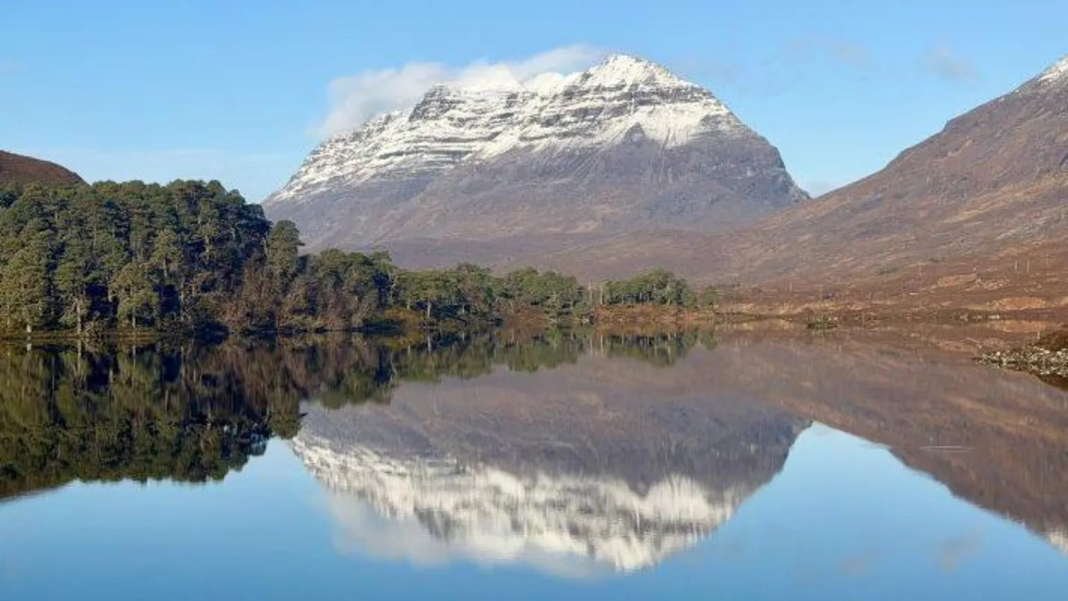 SAIS Torridon A snow-capped Liathach reflected in the mirror-like surface of a loch. 