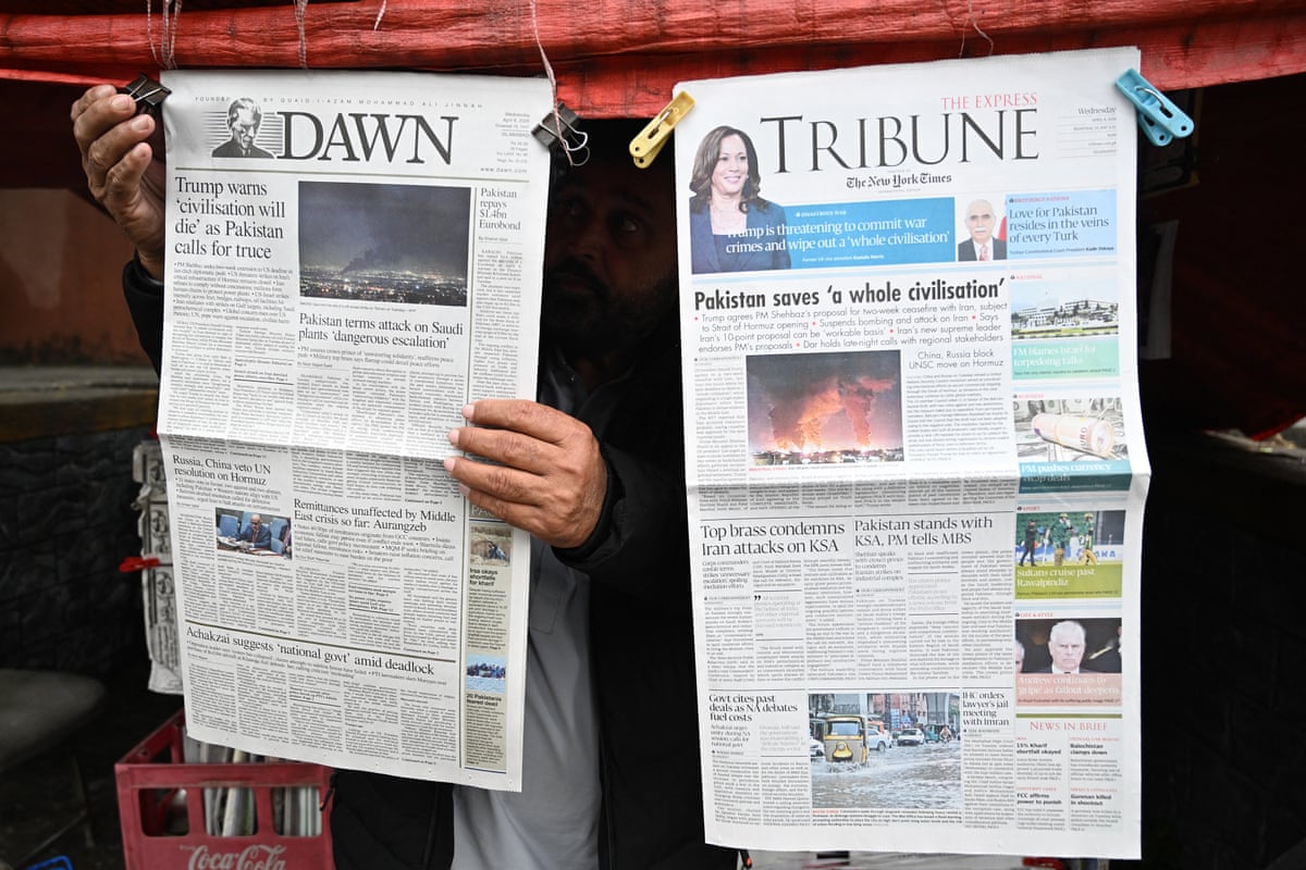 Man hangs up a copy of the New York Times with the headline: Pakistan saves 'a whole civilisation'