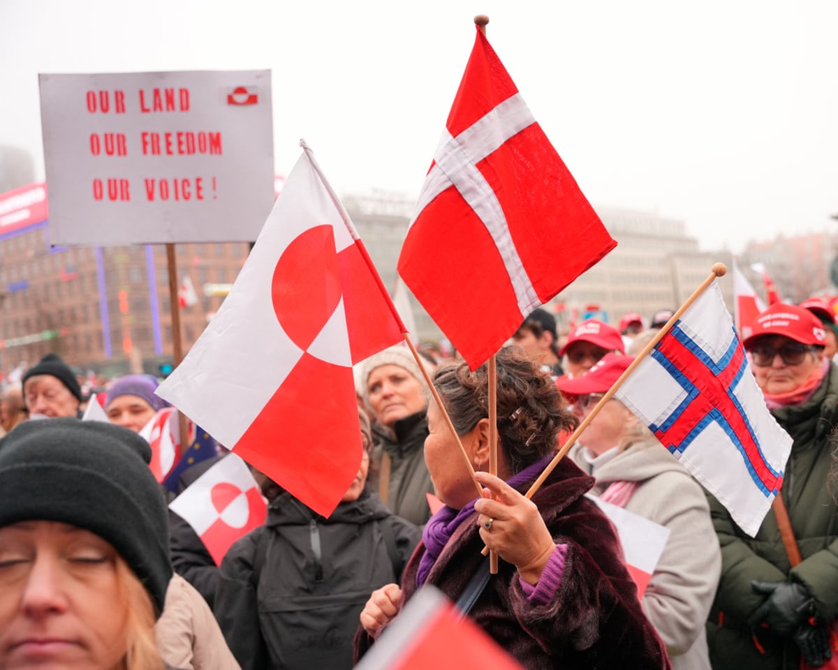 Protesters wave Greenlandic flags