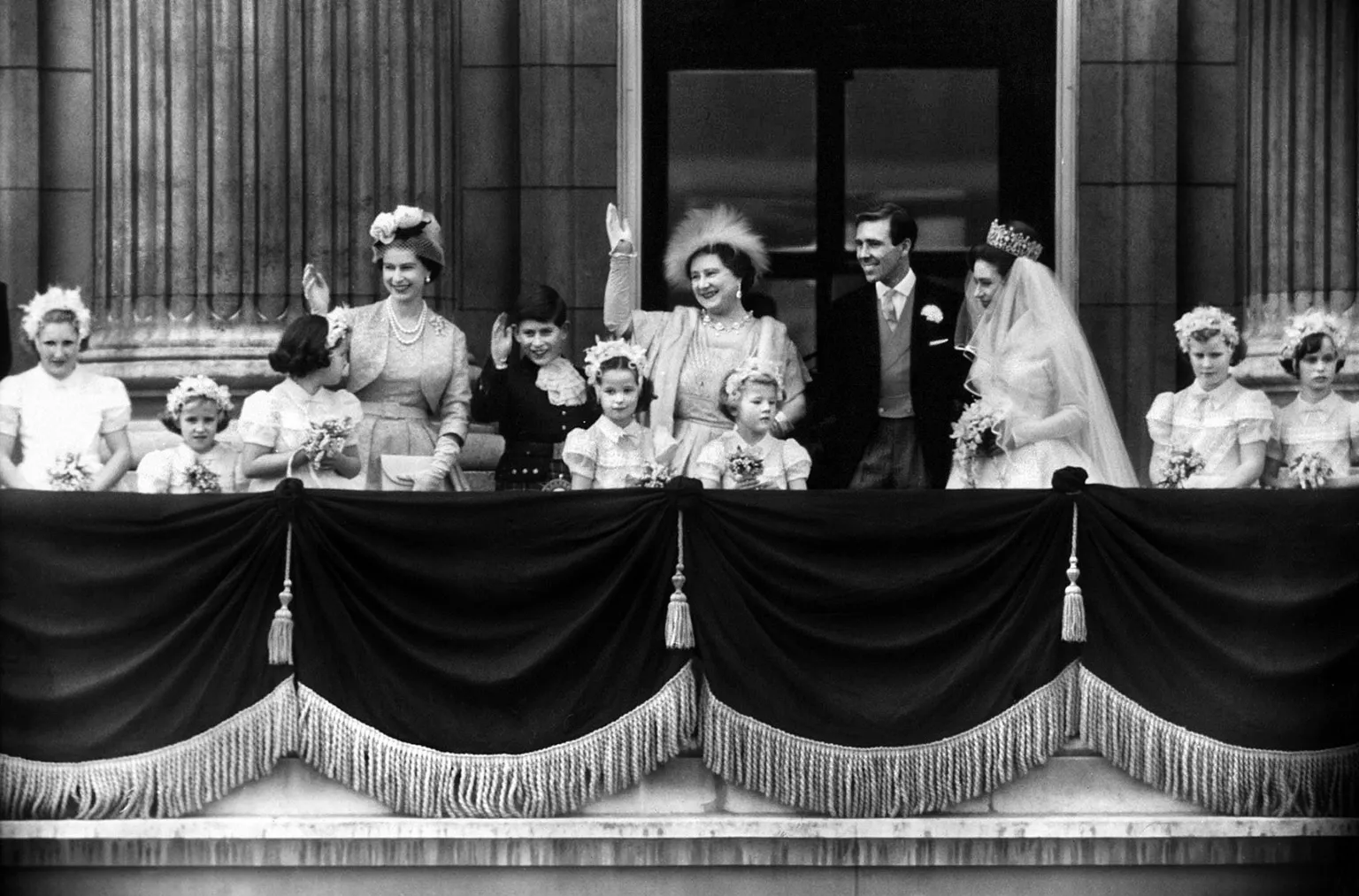 George Greenwell / Mirrorpix via The Queen is seen in the outfit while waving on the balcony of Buckingham Palace alongside the Queen Mother, Princess Margaret and her husband Anthony Armstrong Jones