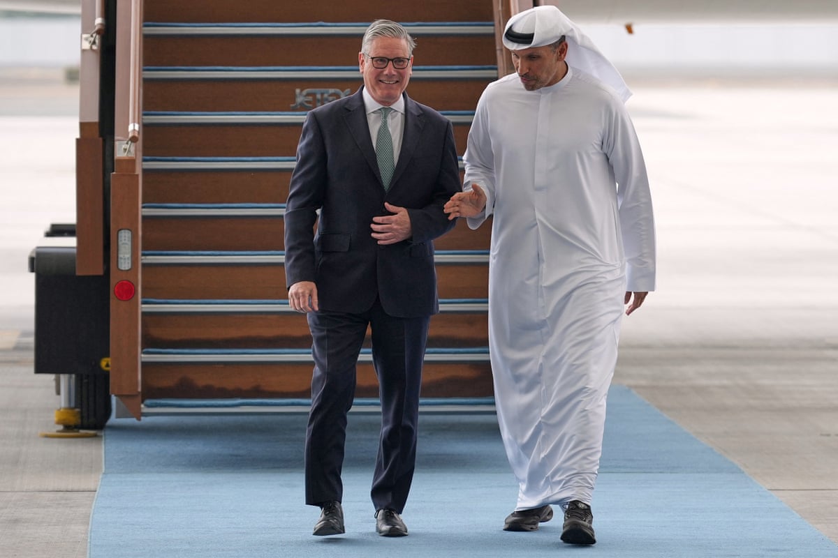 The two men walking down a blue carpet laid in front of some airstairs