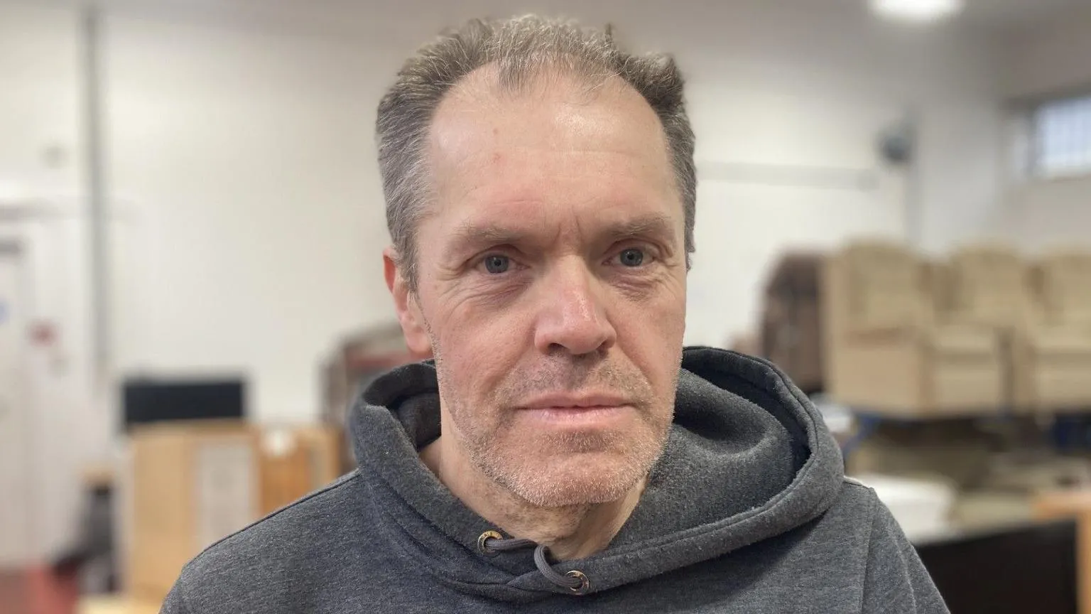 Emma Glasbey/BBC Brian Summerson, who has short grey hair and blue eyes. He is wearing a grey hoodie in the photo.