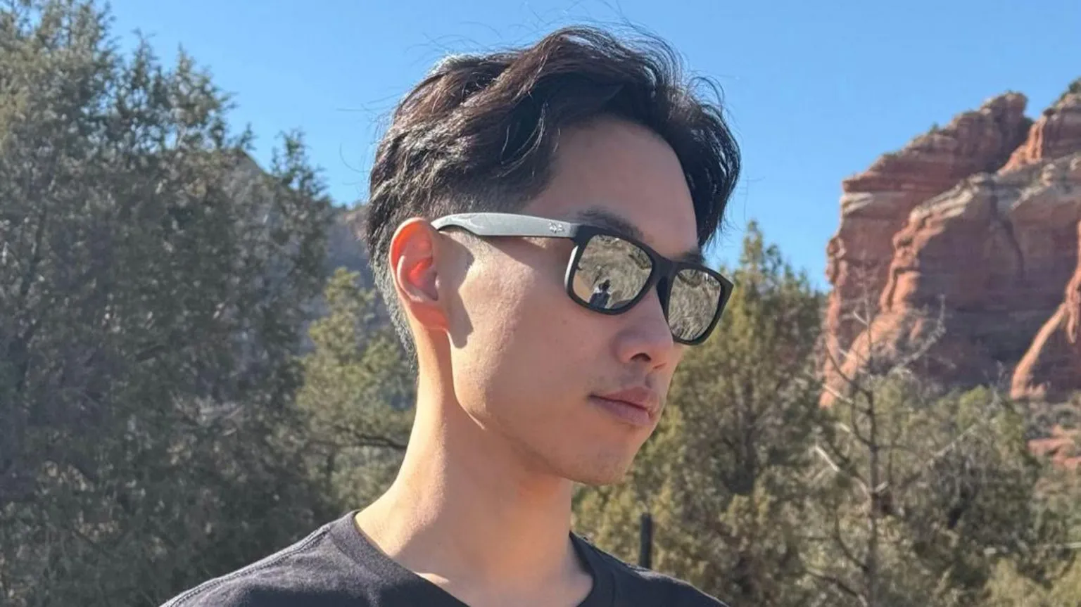 James Tak James Tak looks down while wearing sunglasses in an outdoor setting