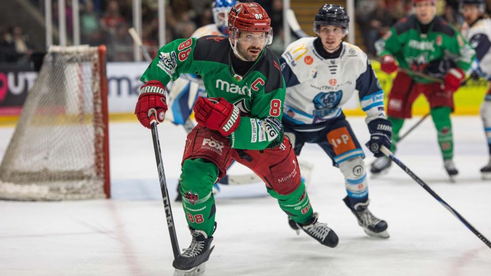 Joey Martin skating close to the Coventry net
