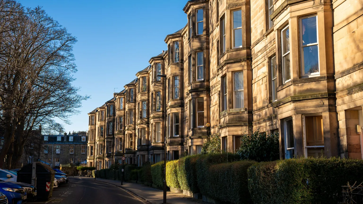 A general view of a street of tenement blocks in Edinburgh in the sunshine.