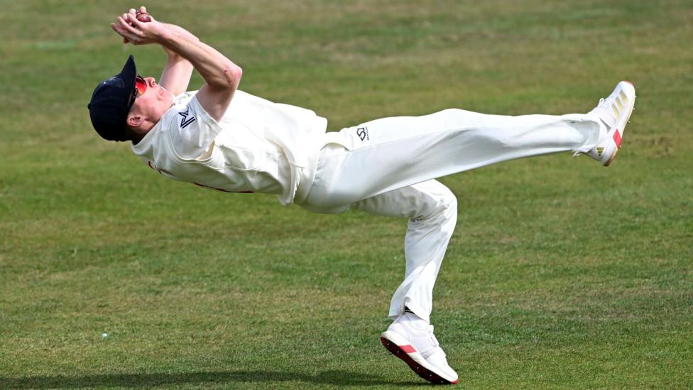 Andy Gorvin falls backwards as he takes a catch for Glamorgan against Nottinghamshire