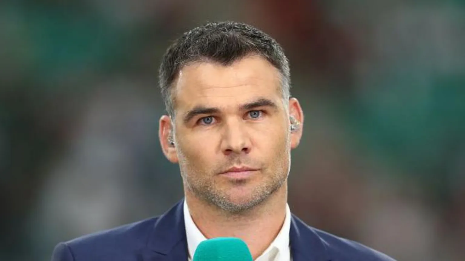 Mike Phillips at the Rugby World Cup 2019. He is wearing white shirt, blue blazer and looking serious
