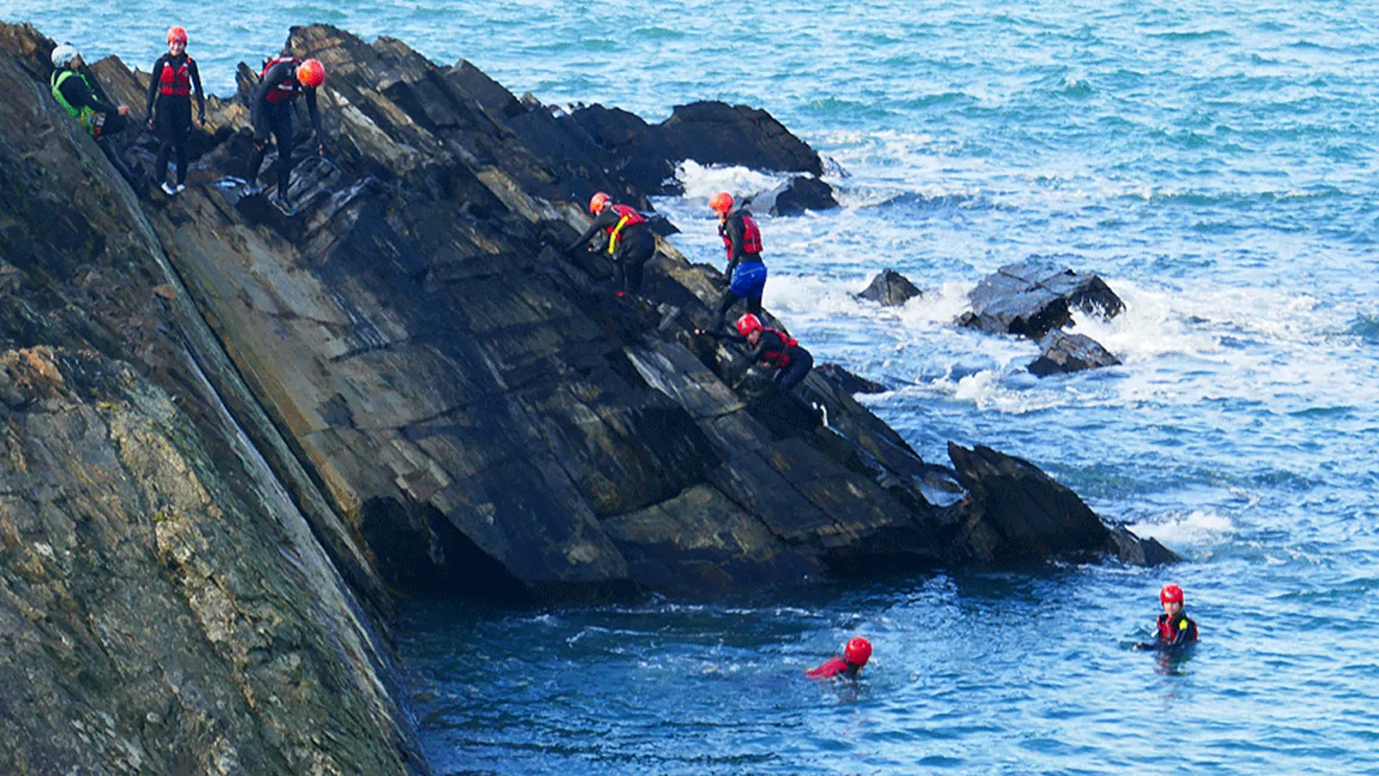 People coasteering near Pembrokeshire's Blue Lagoon