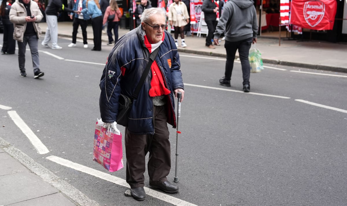 An Arsenal fan makes his way to the Emirates.